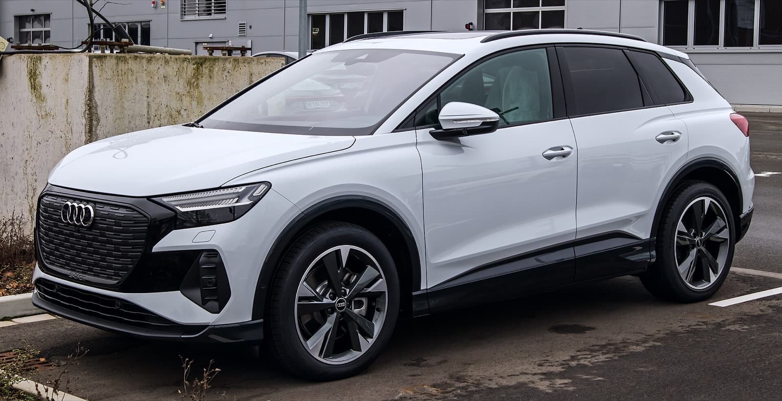 A white Audi Q4 e-tron electric compact SUV photographed front three-quarter