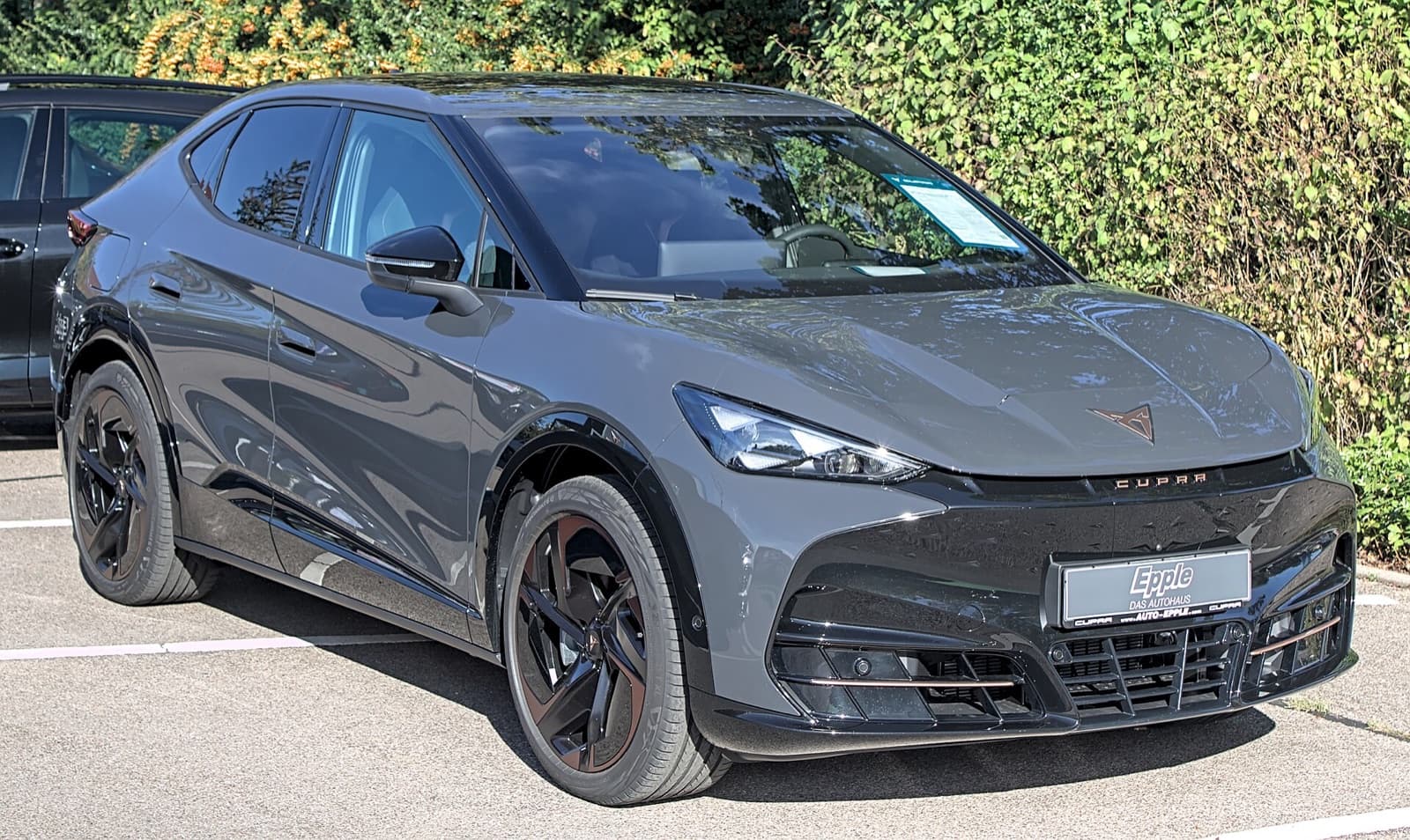 A grey Cupra Tavascan electric coupe-SUV photographed front three-quarter