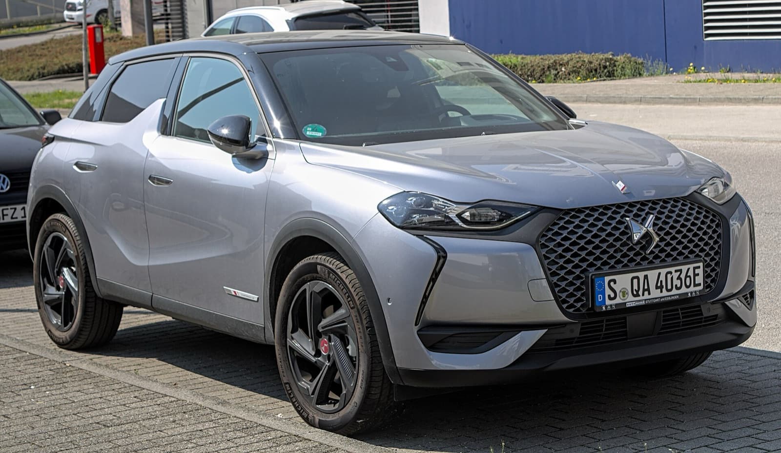 A silver DS 3 Crossback E-Tense electric premium crossover parked on a street