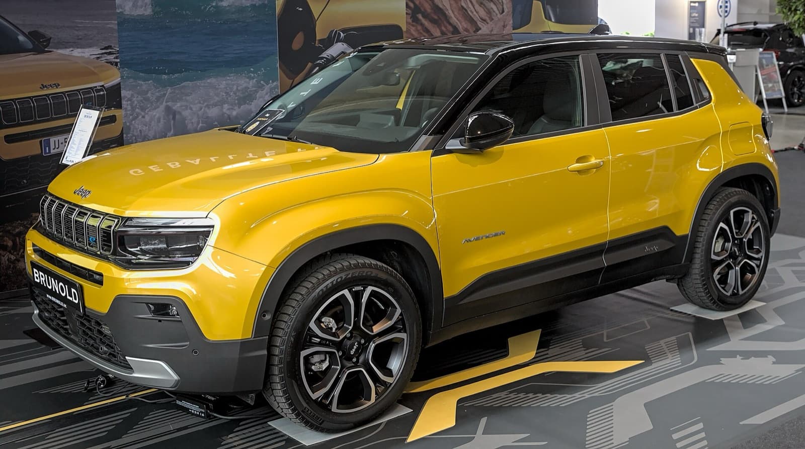 A yellow Jeep Avenger electric small SUV on display
