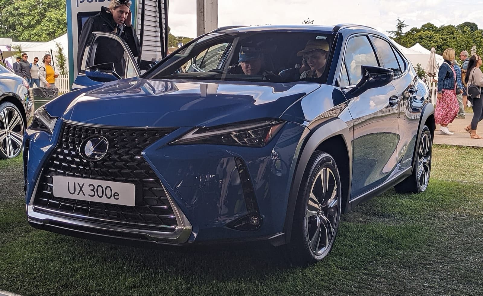 A blue Lexus UX 300e electric compact SUV on display at an outdoor event