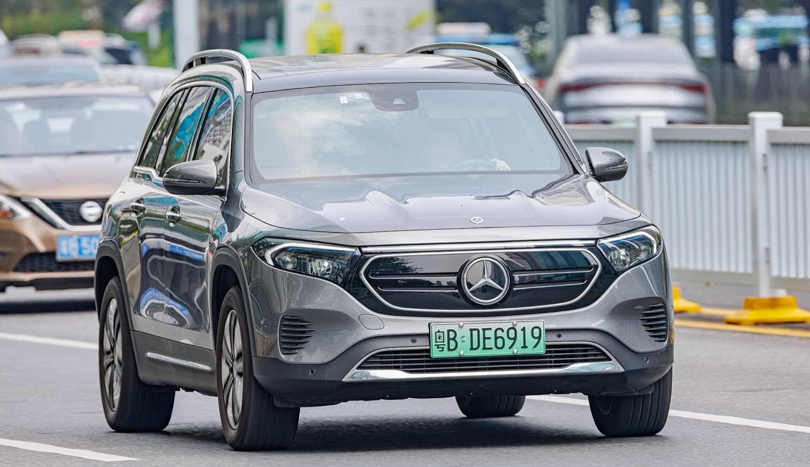 A grey Mercedes-Benz EQB electric compact SUV driving in traffic