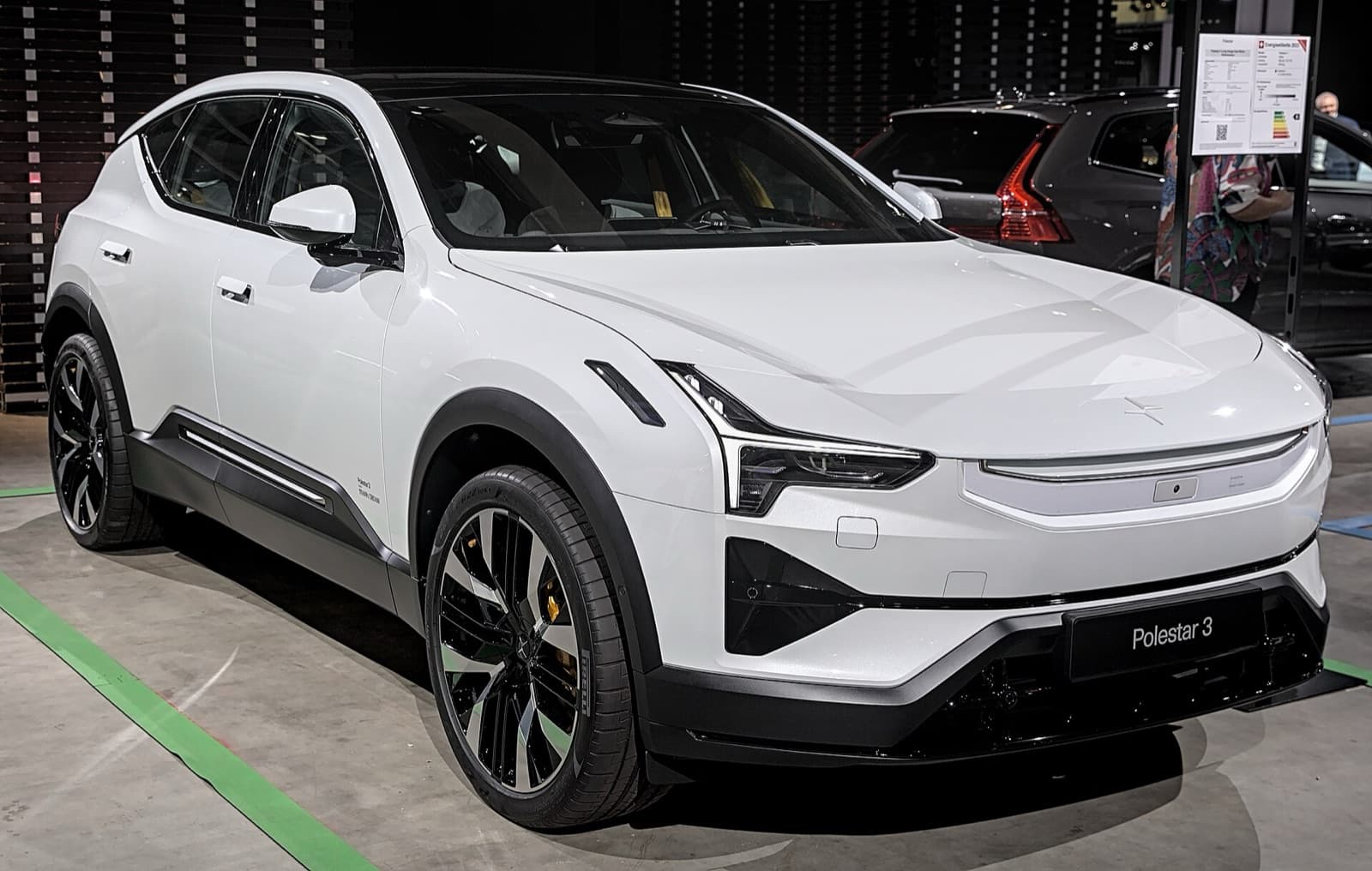 A white Polestar 3 electric SUV on display at a motor show