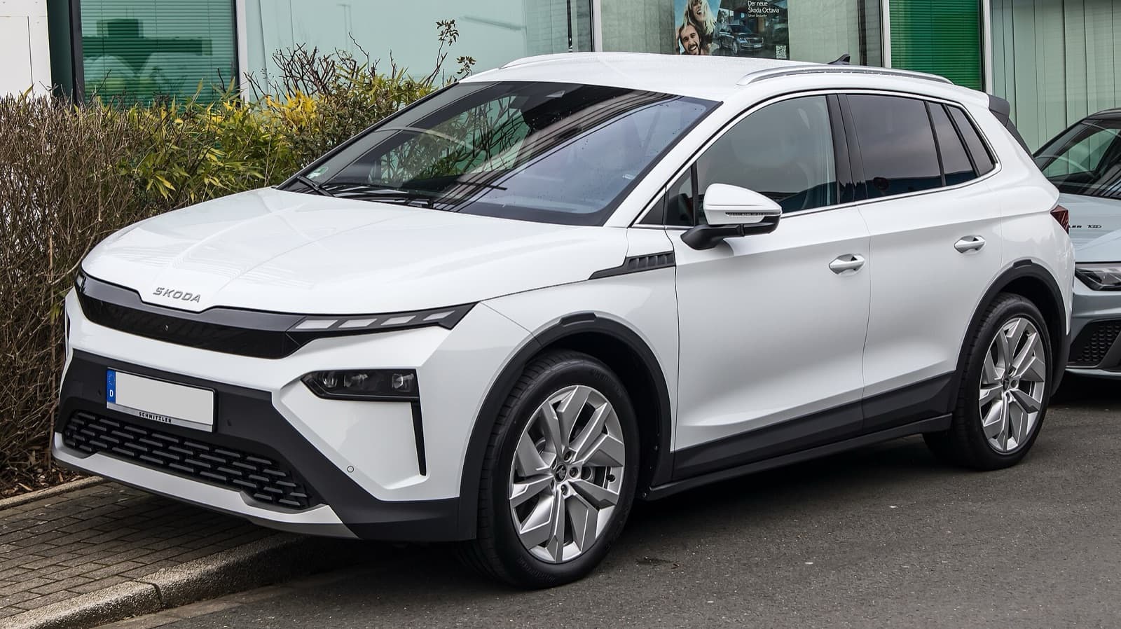 A white Škoda Elroq electric compact SUV photographed front three-quarter