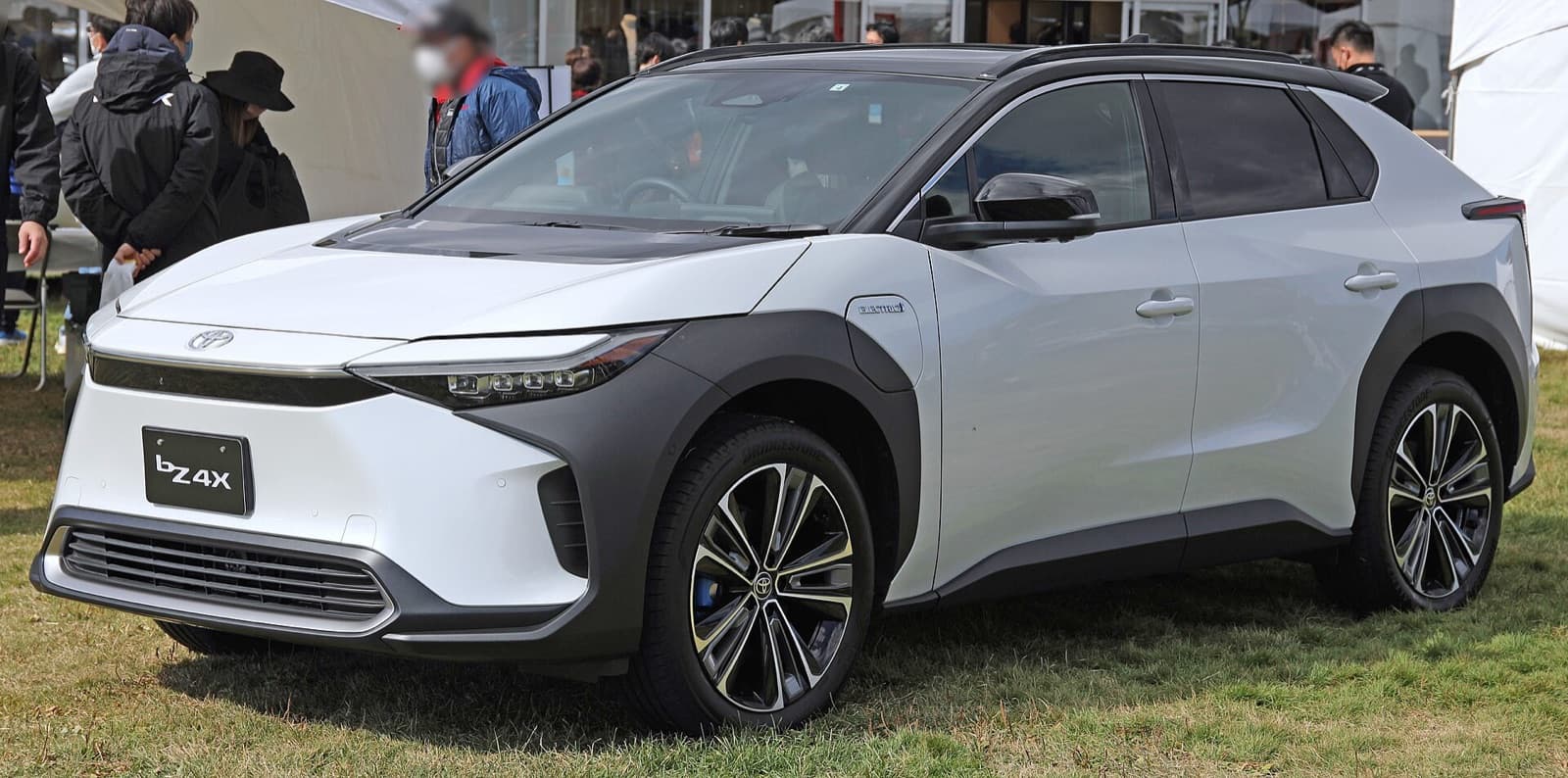 A white Toyota bZ4X electric SUV displayed outdoors, front three-quarter view