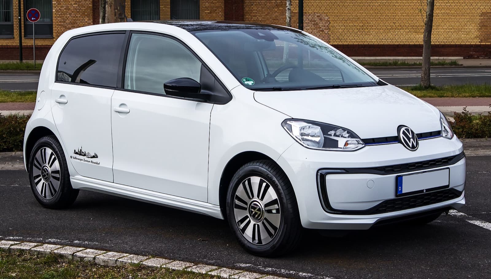 A white Volkswagen e-up! electric city car photographed front three-quarter